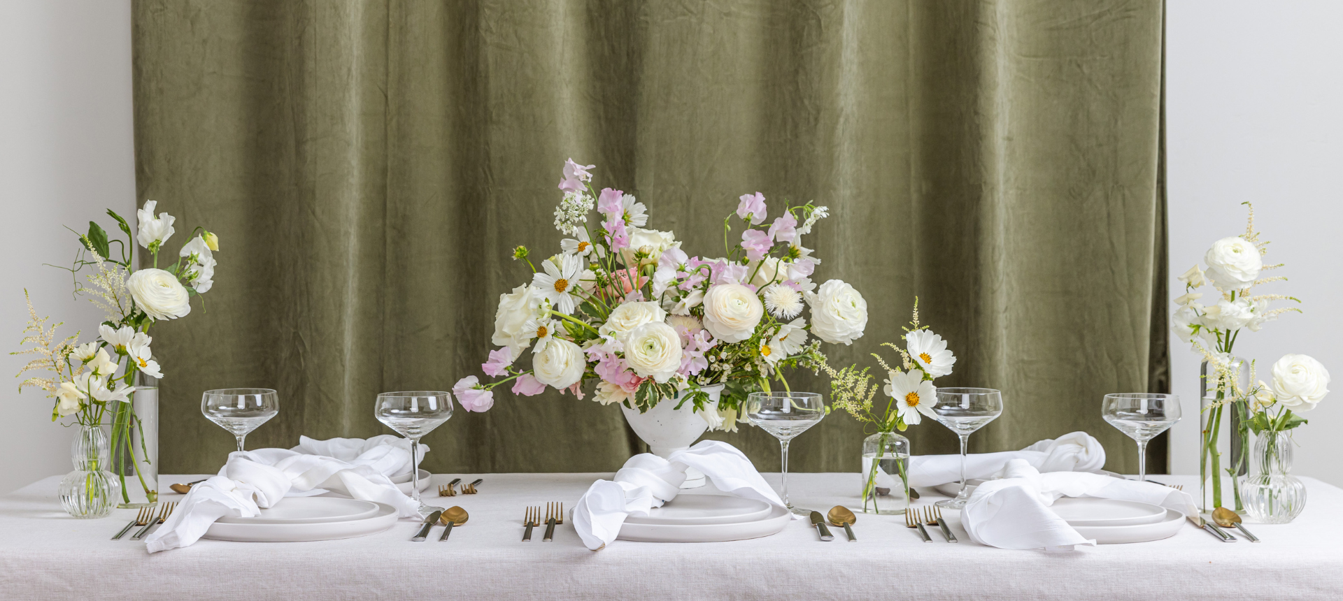 Wedding reception tablescape with garden-style floral centerpiece and bud vase scatter arrangements in white and blush pink seasonal blooms, styled by Flower Bar Co. wedding florist in Midway and Vineyard Utah.