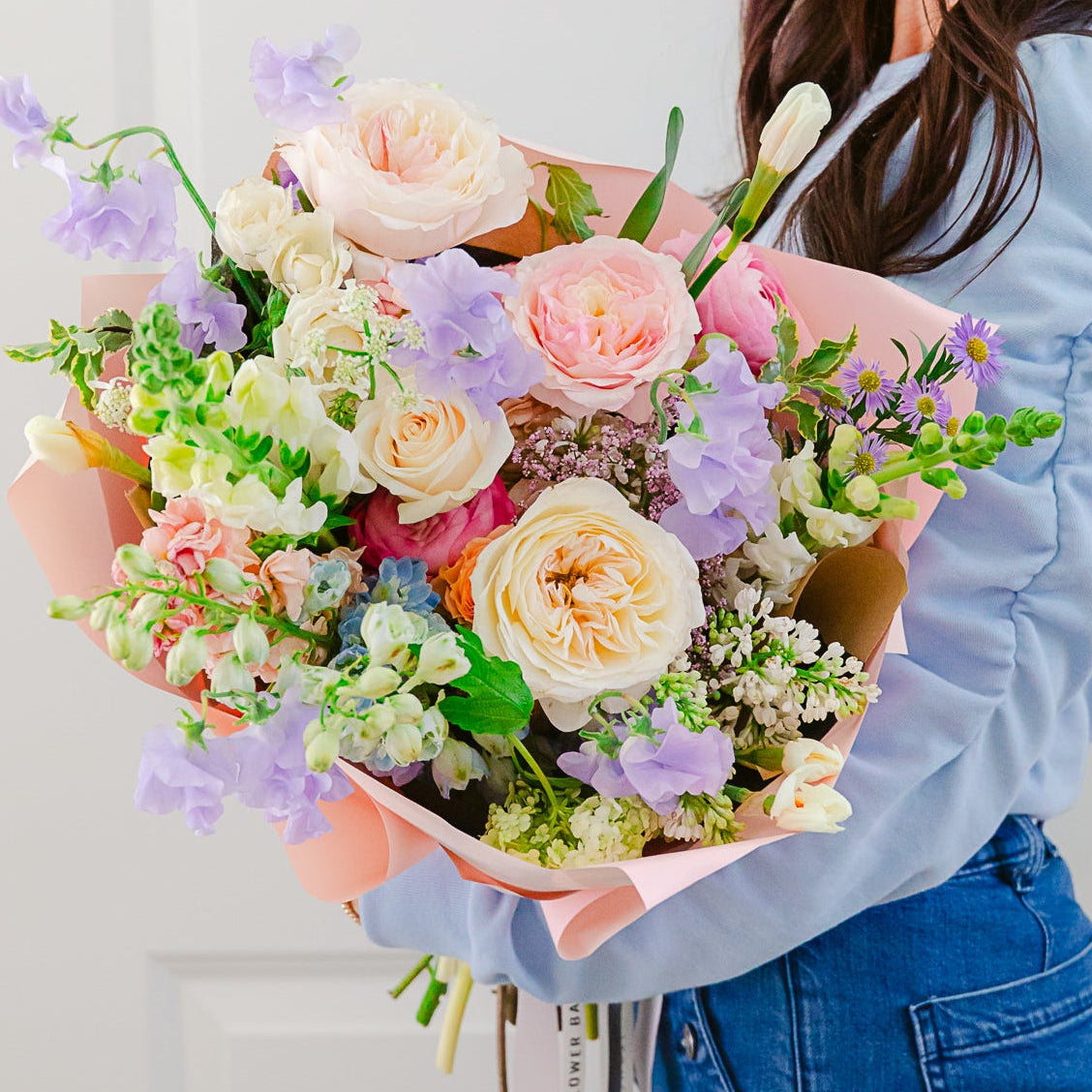 Pastel Easter flower arrangement with soft spring blooms and decorative accents