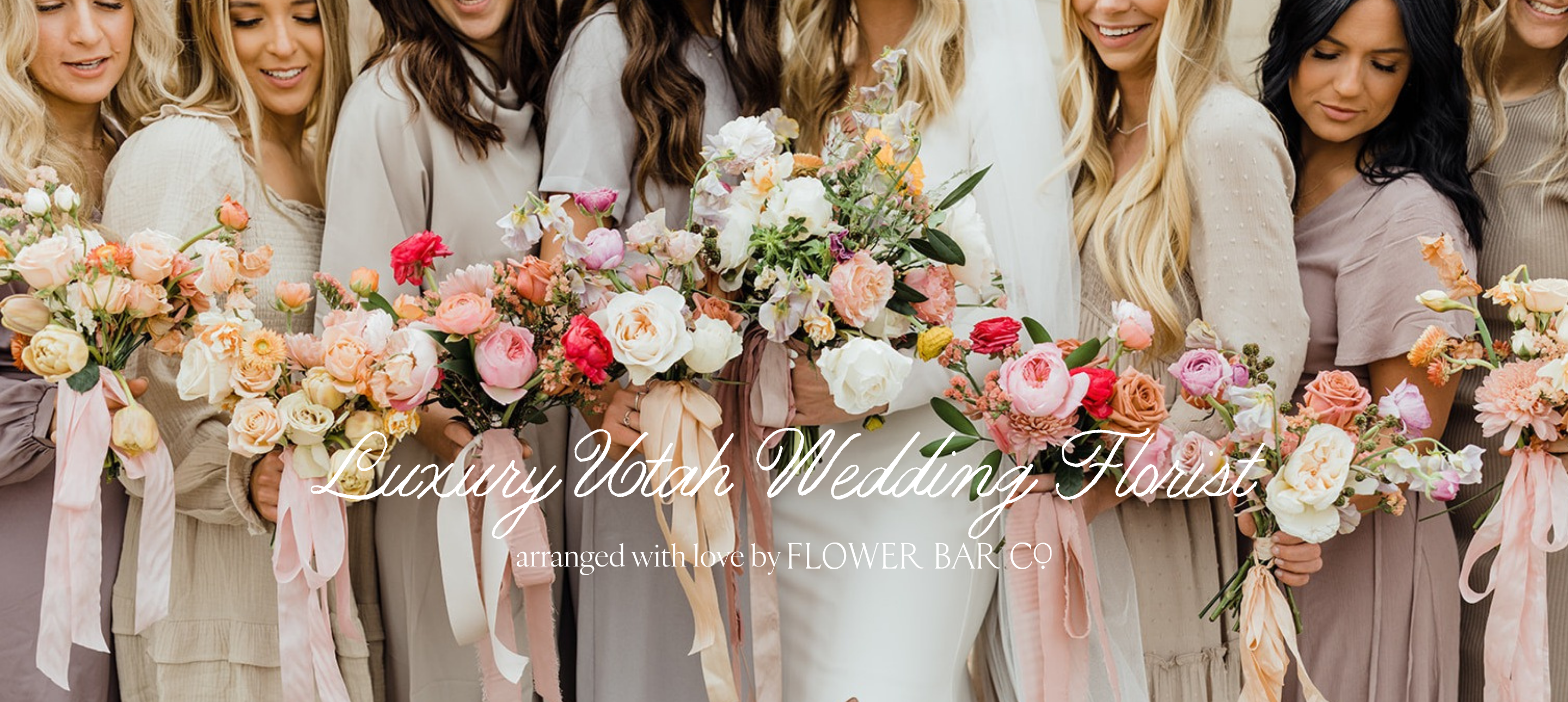 A Utah bride and group of bridesmaids in neutral wedding attire holding matching bouquets of pink, peach, white, and green flowers, with overlaid text reading 'Luxury Utah Wedding Florist' and 'arranged with love by FLOWER BAR CO.'.