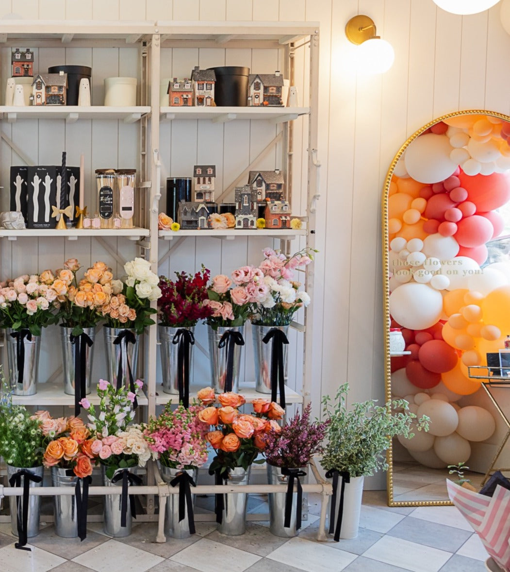 Fresh seasonal stems at our signature Flower Bar alongside fall candles, decorative vases, and autumn home decor at Flower Bar Co. in Midway, Utah.
