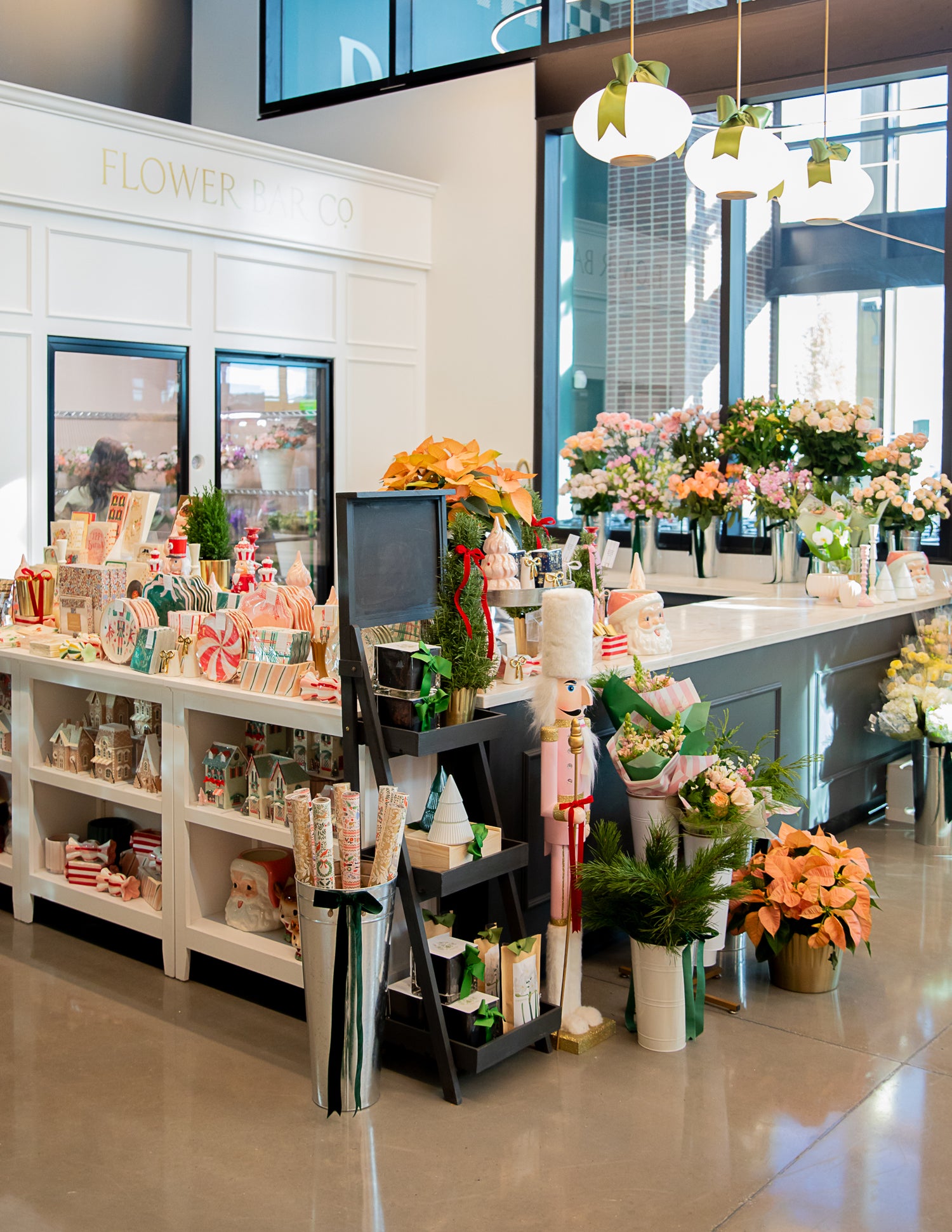A bright Utah flower shop interior with multiple floral arrangements on display counters, gift items and a clean modern retail environment.