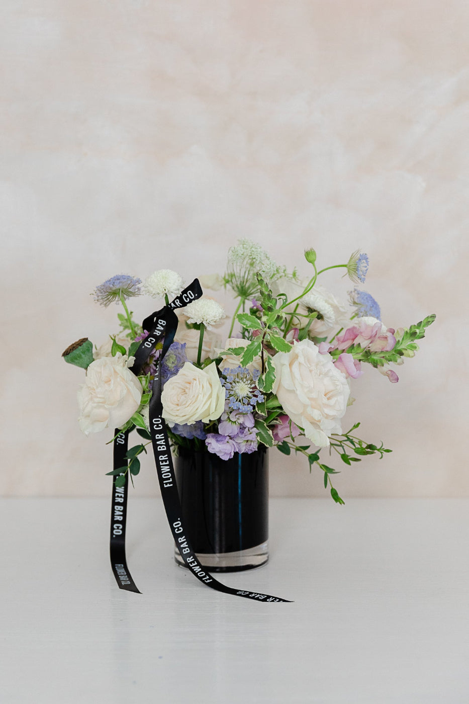 petite flower arrangement in black vase, 