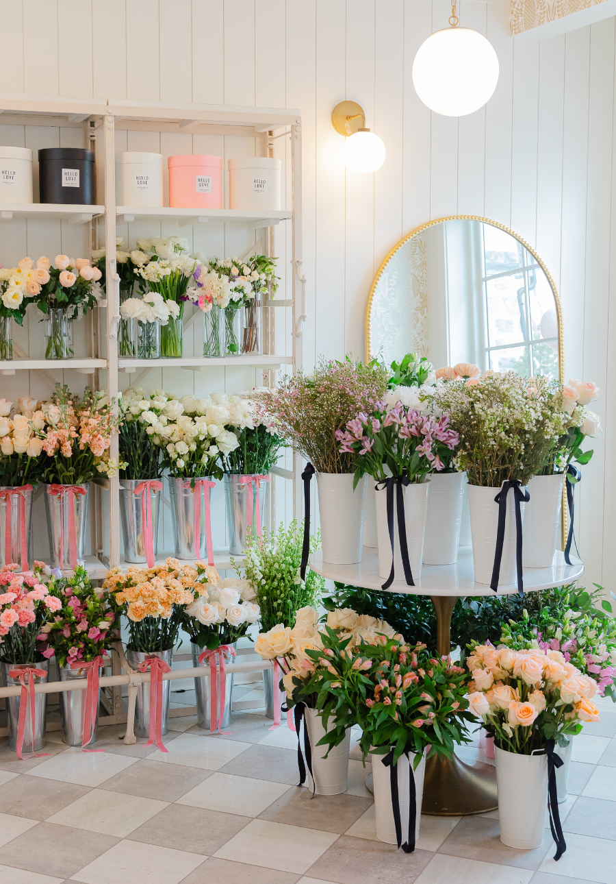 Buckets filled with fresh flower bouquets of pink, peach, cream, and white flowers