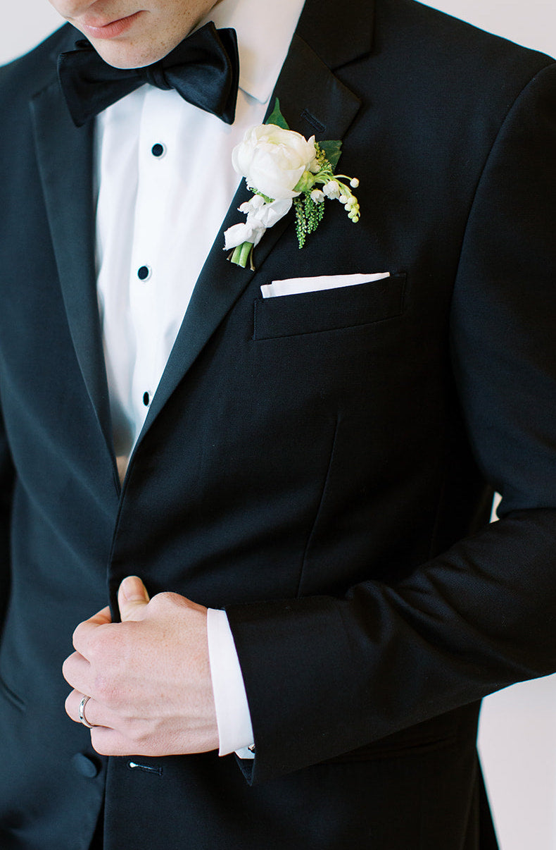 white wedding boutonniere on the grooms lapel