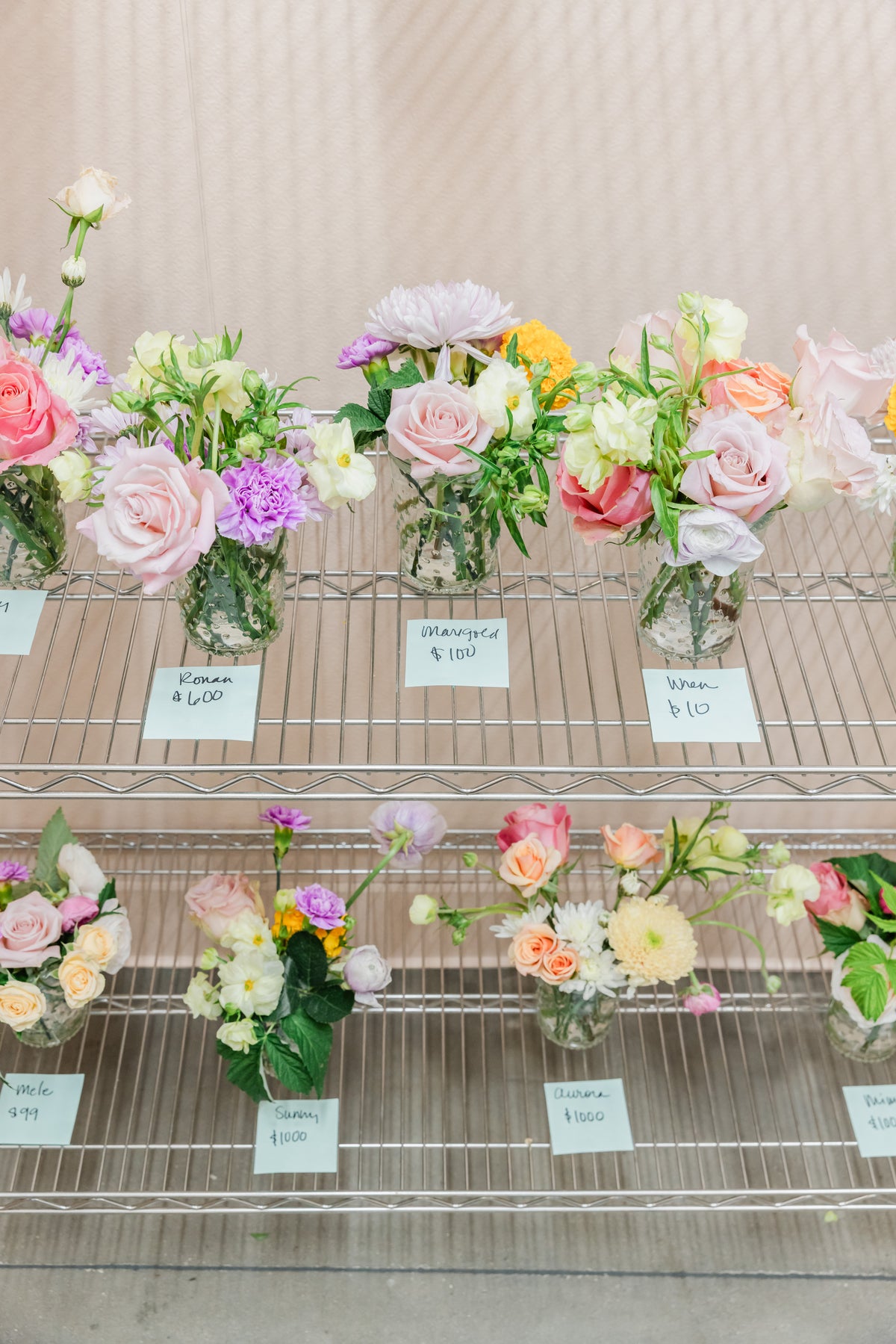 Small floral bouquets made from pink, purple, peach, yellow, and white blooms with green stems