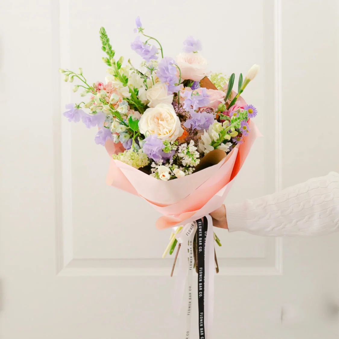 Premium wrapped flower bouquet with elegant flowers and lush seasonal greenery