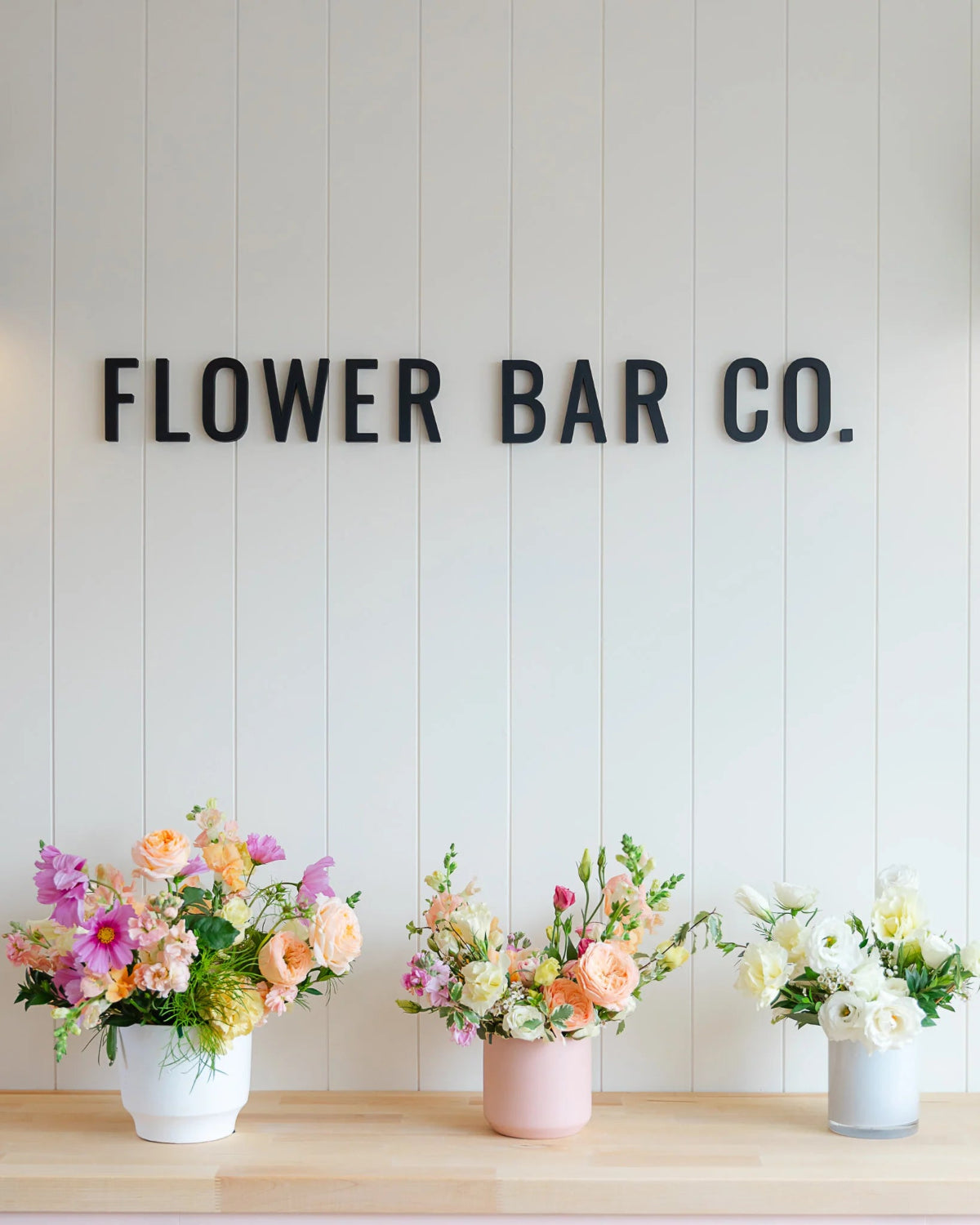 three varying sized flower arrangements