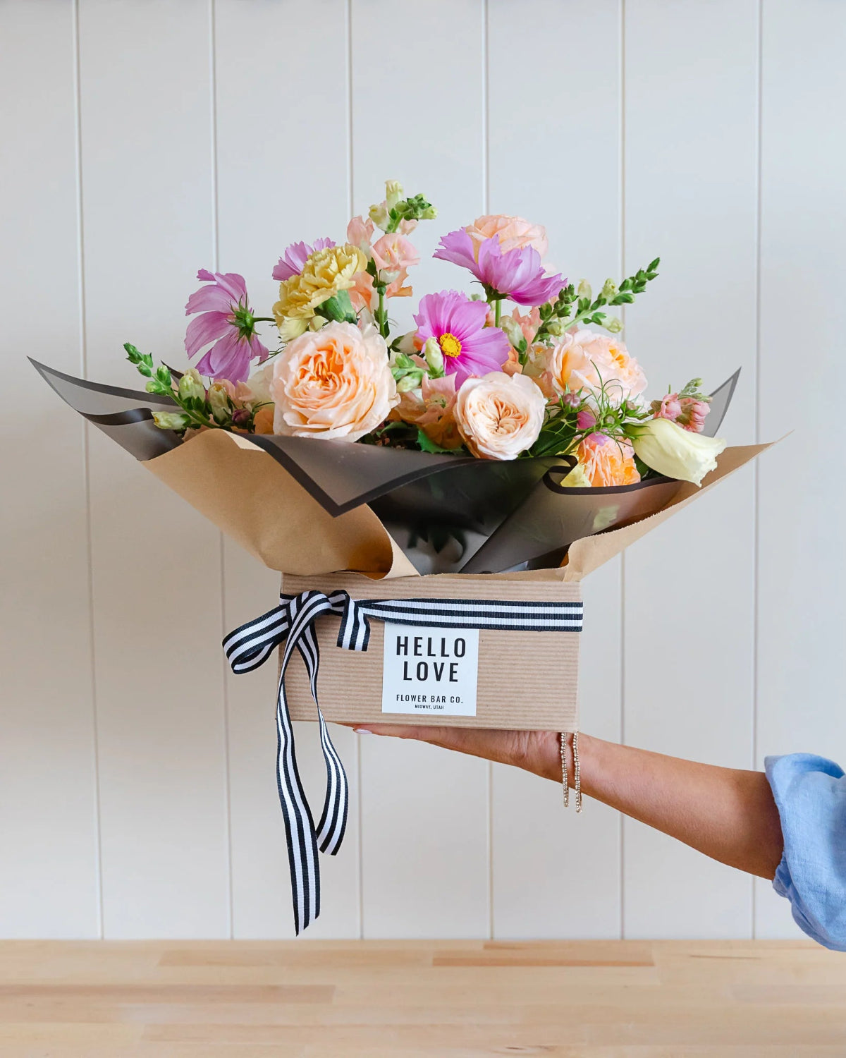 Premium vase arrangement with elegant flowers and lush seasonal greenery